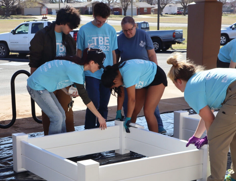 Volunteers building garden beds