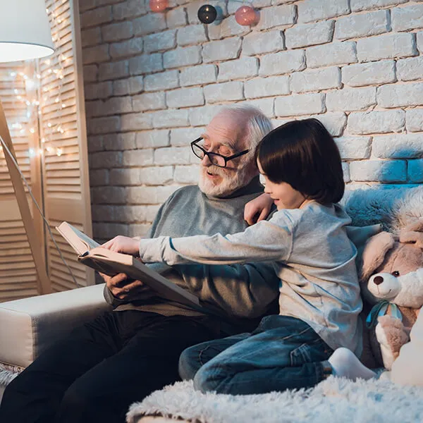 Grandfather reading to grandson