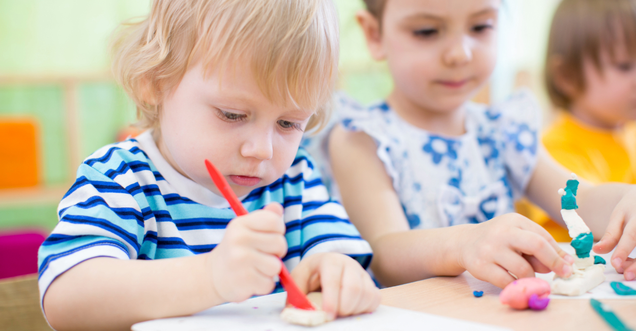 Kids clay a preschool age boy and girl creating with clay