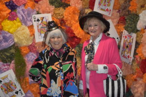 posing in front of a vibrant, themed backdrop.